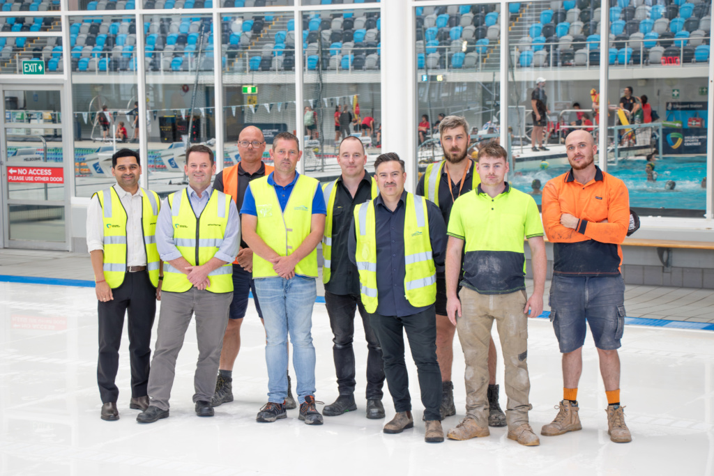 State Sport Centres Facilities staff and the team from Commercial Aquatics stand on the newly installed multipurpose pool.
